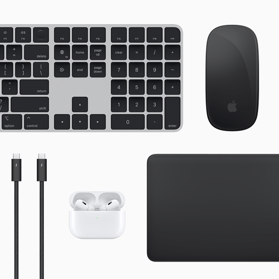 Vista superior de varios accesorios del Mac: un Magic Keyboard, un Magic Mouse, un Magic Trackpad, unos AirPods y cables Thunderbolt.